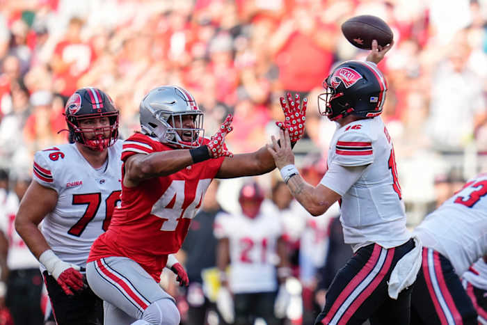 Sep 16, 2023; Columbus, Ohio, USA; Ohio State Buckeyes defensive end JT Tuimoloau (44) pressures Western Kentucky Hilltoppers quarterback Austin Reed (16) during the NCAA football game at Ohio Stadium. Ohio State won 63-10.  